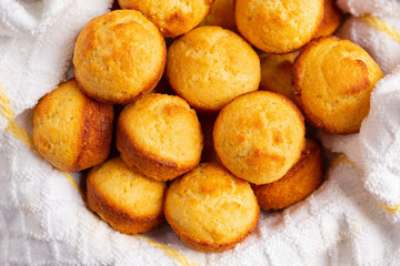 Corn bread muffins on a white and yellow dish towel - Powered by Adobe