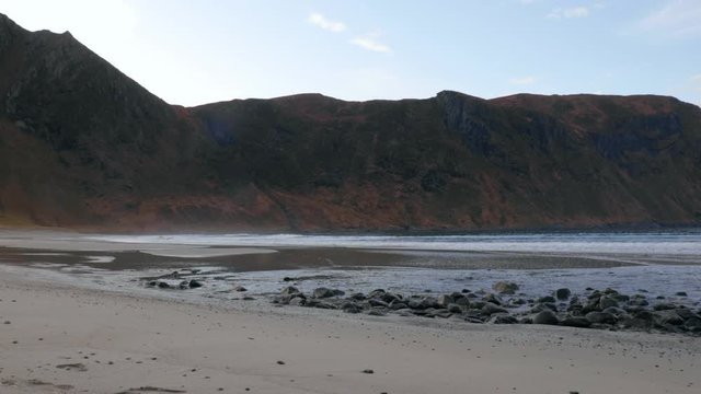 Beach with waves coming into land Hoddevik Norway