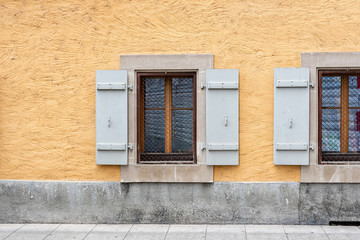 Windows with shutters on the wall of an old building in Geneva, Switzerland