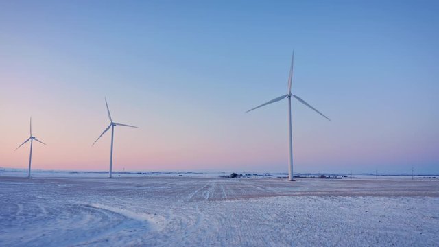 Aerial: Flying Over A Renewable Energy Wind Farm Covered In Snow. Alberta, Canada