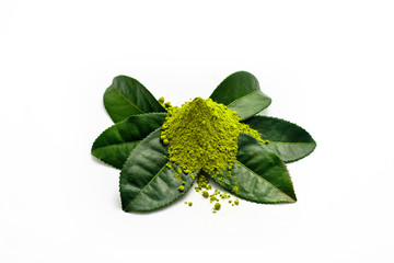 Heap of extracted green tea powder on fresh green tea leaves in white background.
