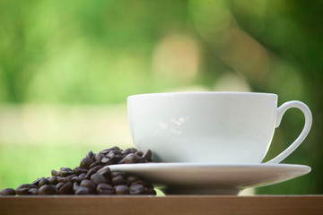 Paper cup take away coffee on a wooden bench in the park