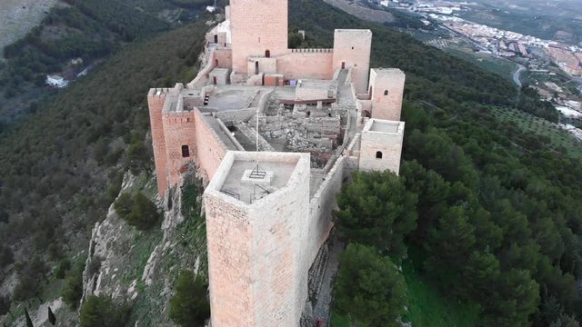 Jaen's Castle Saint Catalina Castle Spain shoot with a drone at 4k 24fps showing the exterior and the city from multiple points on a afternoon in December.