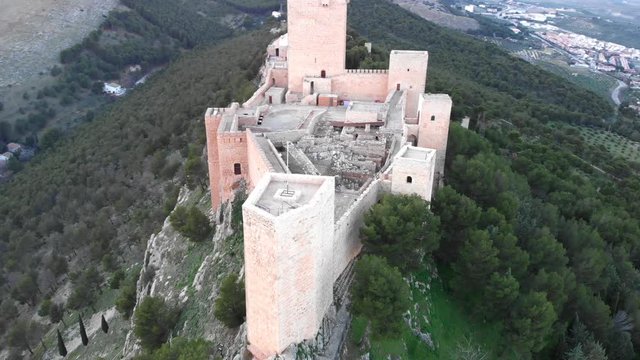 Jaen's Castle Saint Catalina Castle Spain shoot with a drone at 4k 24fps showing the exterior and the city from multiple points on a afternoon in December.