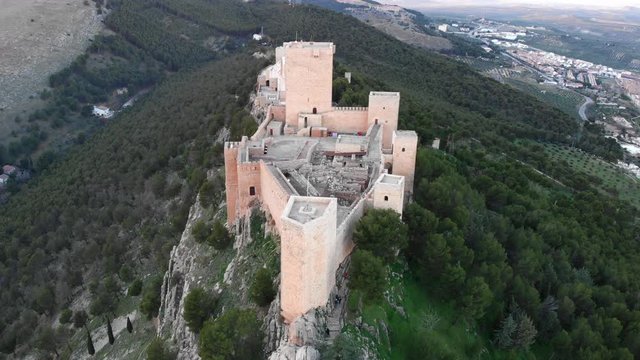 Jaen's Castle Saint Catalina Castle Spain shoot with a drone at 4k 24fps showing the exterior and the city from multiple points on a afternoon in December.