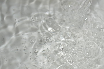 The surface of the water in a white container