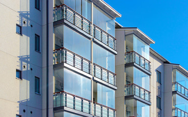 Apartment in residential building exterior. Housing structure at blue modern house of Europe....