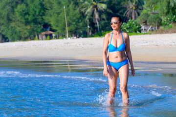 Woman shpae big and bikini blue relax on wave