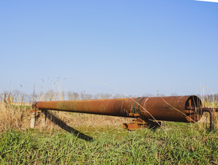 Gas pipeline through irrigation canal in a protective steel pipe.