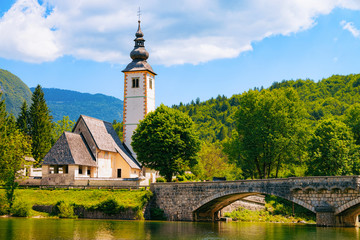 Scenery of Church of St John Baptist on Bohinj Lake at Slovenia. Nature in Slovenija. View of blue...