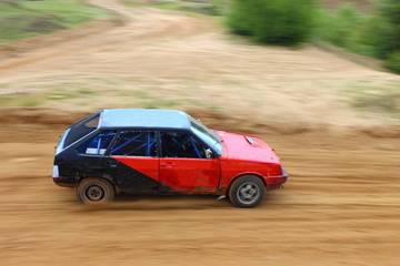 Fototapeta na wymiar Russian front wheel drive red black racing car on off road racing closeup, auto cross competition