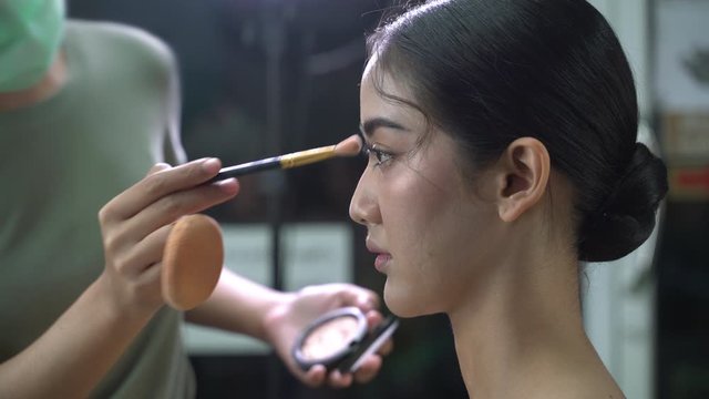 Make-up artist putting on make-up on model's Make-up Artist at work
