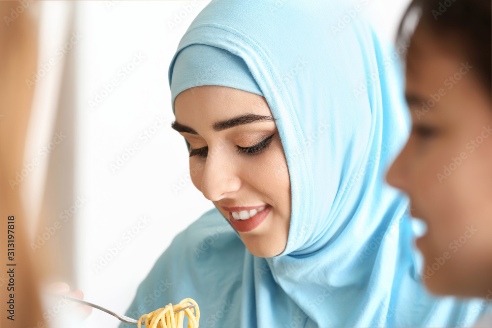 Wall mural Muslim woman having dinner at home