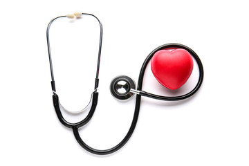 Stethoscope and heart on white background