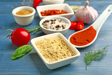 Many different spices on wooden background
