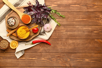 Many different spices on wooden background