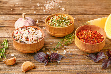 Many different spices on wooden background