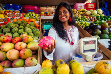 smiling indonesian business woman in kerala goa sell fruit and vegetable farm
