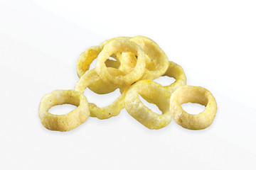 Fried Spicy, Salty and tasty fried corn rings Snacks or Fryums (Snacks Pellets) Salty Mini Ring Snack, white background, selective focus - Image