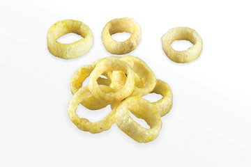 Fried Spicy, Salty and tasty fried corn rings Snacks or Fryums (Snacks Pellets) Salty Mini Ring Snack, white background, selective focus - Image