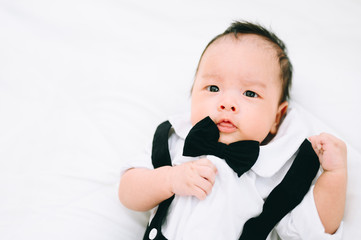 Happy 2 month baby. Little boy in a white shirt and bow tie. Children portrait. Stylish man in fashionable a bow-tie tuxedo.
