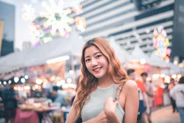 Traveler Asian blogger women travel in Bangkok, Thailand, beautiful female using .Travel vacation at night in the city concept, Young happy traveler asian woman  and backpack walking