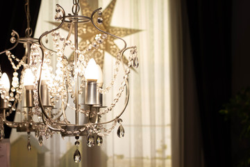elegant chandelier in a cozy interior, a star in the background