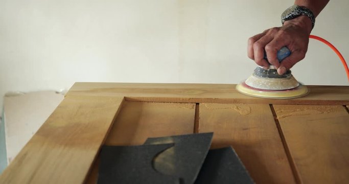Woodworking. Sanding on Wooden door in 4k slow motion