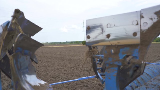 4K. Metal ploughshare for plough field in agriculture area. Preparation for harvest, steady shot