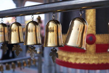 Hanging little golden bells on blur background