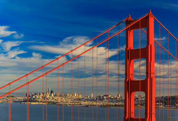 San Francisco skyline through the steel ropes of the famous Golden Gate bridge viewed from Marin Headlands, California