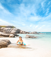 Fototapeta na wymiar Young and beautiful woman in swimsuit relaxing on the beach. Girl having summer vacation in Thailand. Holidays and traveling.