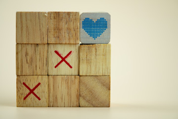 Wooden cubes tic tac toe board game with cubes heart on top