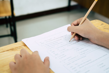 English exams test student in school, university students holding pencil for testing exam writing...