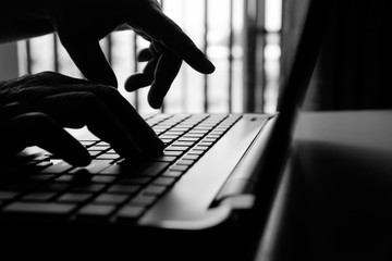 hacker or cyber crime hand reaching, stealing information on laptop, attack signifying internet...