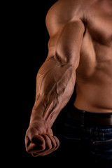Fototapeta na wymiar Muscled male model flexing biceps