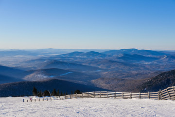 Winter landscape in Sheregesh. Frozen snow on trees. Frozen trees on a background of blue cloudy sky. A lot of snow fell in the winter cold in the mountains. Sunrise in the mountains