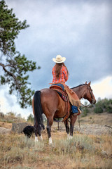 Obraz premium Cowgirl Riding on Rocks