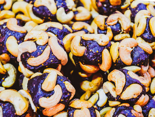 Slices of marmalade with cashew nuts. Cashews with sweets. Marmalade balls with nuts.