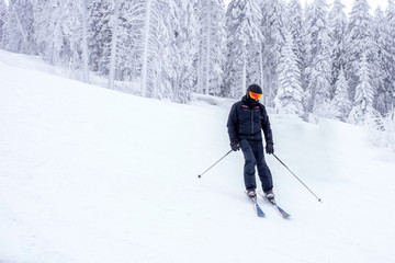 Man on ski piste at skiing resort during winter vacation
