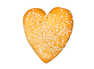 Homemade heart shaped cookie with sesame seeds baked for Valentine day 14 February isolated on white background.