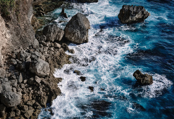 Aerial view to sea landscape, water with waves and rocks. Dramatic colors photo.