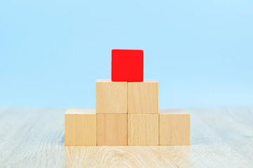 Wooden block toy stacked in pyramid shape without graphics for Business design concept and activity  for child foundation practice skills.