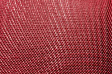 Fototapeta premium Close-up abstract flat red high detail textured clothing fabric pattern background in partial focus and realistic light