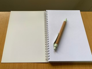 A note book with a pen