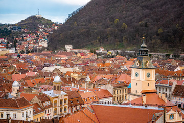 Fototapeta na wymiar Panoramic view of Brasov from White tower and Black tower in the evening during spring season . One of the most famous view points in the heart of Brasov , Transylvania , Romania