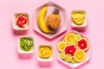Tropical fruits whole and slices on plates