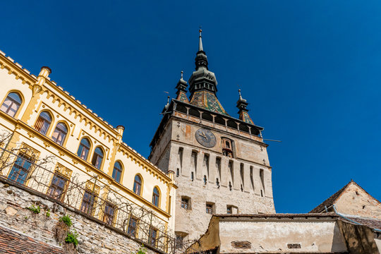 The clock tower in old town of Sighisoara  afternoon during spring season . One of the most impotant tower . Also Sighisoara is Unesco sites of the country , Sighisoara , Transylvania , Romania