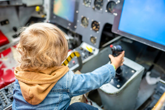 Child at the controls of an aircraft simulator