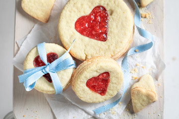 Homemade biscuits for valentine with red strawberries jam